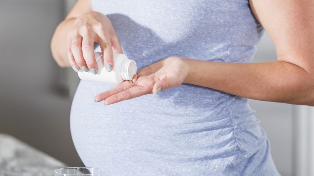 Midwest Fertility Center-woman taking pill